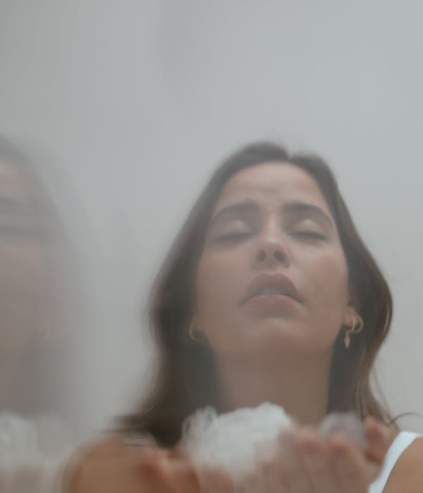 Woman in a calm, focused state, surrounded by soft olive light.